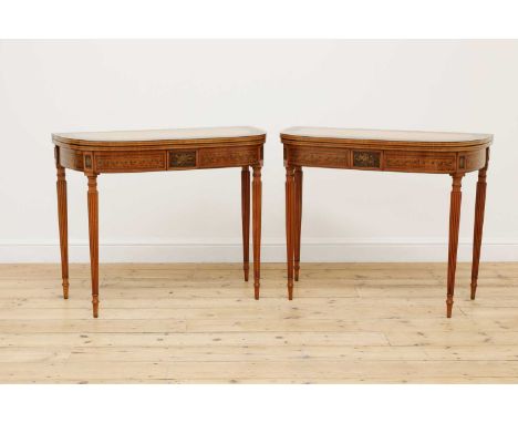 A pair of George III satinwood and painted card tables, c.1800, each hinged D-shaped top with a Greek key border, opening to 