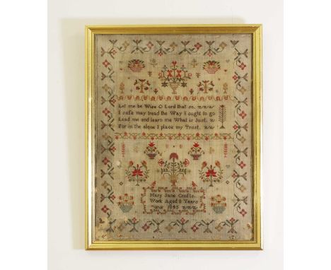 A 19th century needlework sampler,worked by 'Mary Jane Crofts, aged 8 years, 1845', with a verse within baskets and urns of f
