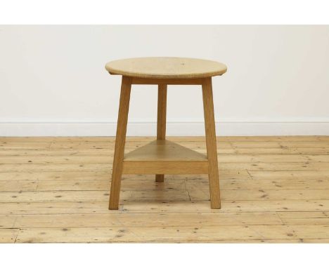 An oak 'cricket' table,contemporary, by Axel Vervoordt, the three legs united by an undertier,59cm diameter68cm highCondition