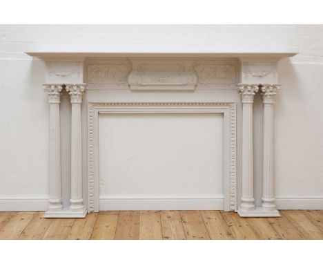 A white-painted fire surround,probably 18th or 19th century, the shaped frieze decorated with floral swags, above the apertur