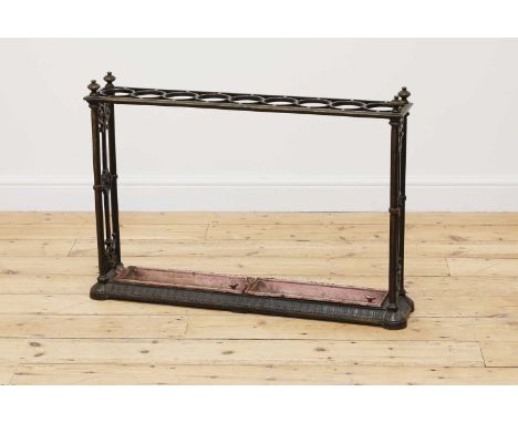 A Victorian cast iron stick stand by Coalbrookdale,with a brassed finish, the top with nine circular apertures on cast end su