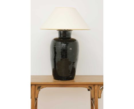 A large treacle-glazed pottery table lamp,20th century, fitted with a large shade,60cm highCondition report: Height not inclu