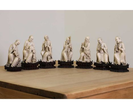 A set of eighteen Chinese carved ivory figures,19th century, on wooden stands, described as the 'Disciples of Lohan', each po