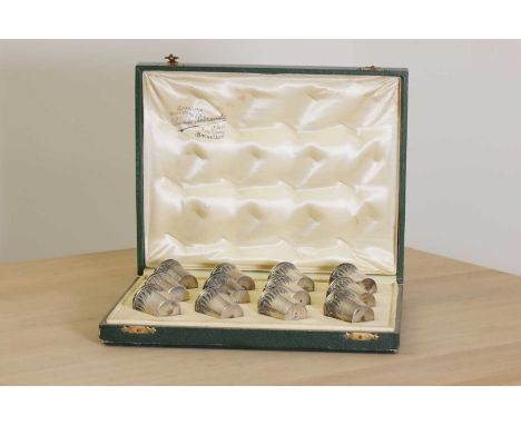 A set of twelve silver vodka cups,early 20th century, Belgian, each of tapering form and with a band of chased decoration, ea