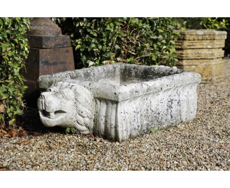 A carved marble trough,20th century, North West Indian, of rectangular form with a lion mask handle to either end,15cm wide 6