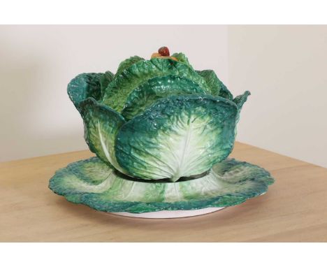 A porcelain cabbage tureen,19th century, French, probably by Jacob Petit of Paris, the lid with a finial in the form of carro