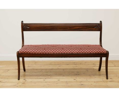 A rosewood bench,19th century and later, with a curved bar back over a caned seat, raised on sabre legs, 135cm wide48cm deep8