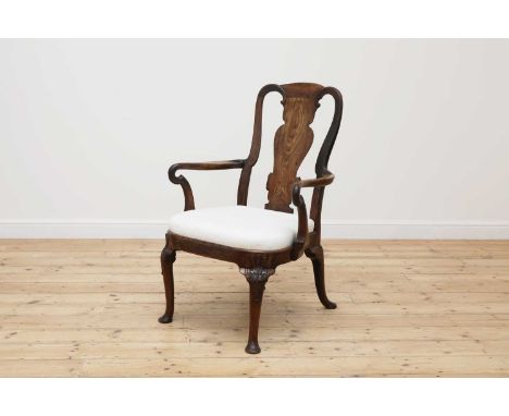 A George II mahogany elbow chair,with a vase splat back and shepherd crook arms over a drop-in seat, with carved cabriole leg