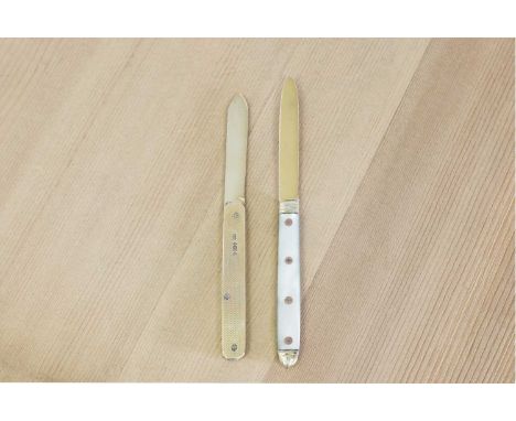 Two gold folding fruit knives,the first by William Needham, Sheffield 1924,the handles engine-turned 9ct gold, the blade silv