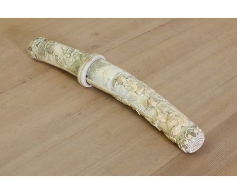 A Japanese carved ivory short sword,Meiji period (late 19th century), finely decorated with two relief figure groups, incised