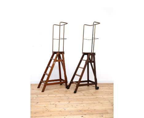 Two sets of pine library steps by Slingsby,20th century, each with four steps to a platform with a tubular metal frame, the r