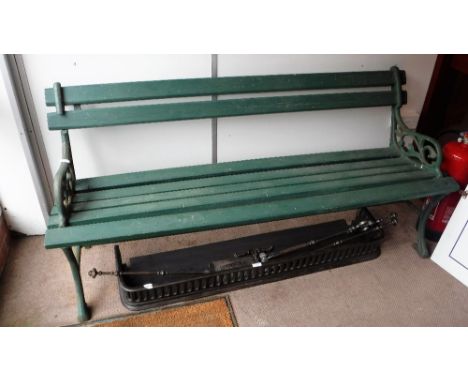 A VICTORIAN CAST-IRON GARDEN BENCH with wooden slats, painted green, 66" long (some older restoration)