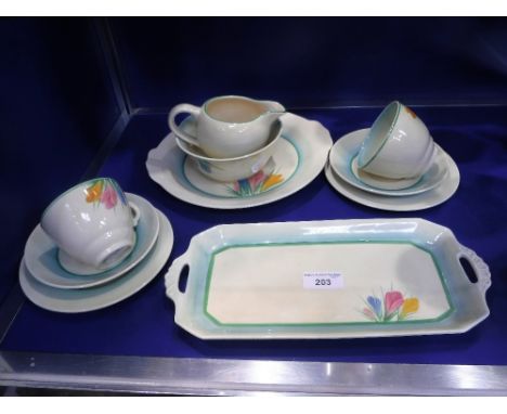 A CLARICE CLIFF PART TEA SERVICE with 'Crocus' decoration on blue and cream ground, comprising sandwich plate, two teacups an