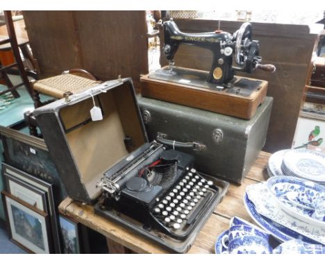 A VINTAGE ROYAL TYPEWRITER and a Singer sewing machine