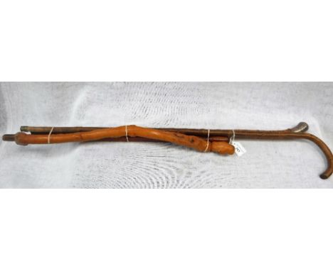 A BAMBOO WALKING STICK with white metal handle and other various sticks