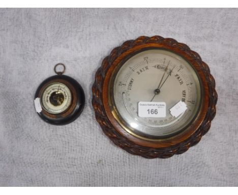 A 1920'S OAK WALL BAROMETER with silver dial and one other smaller barometer (2)