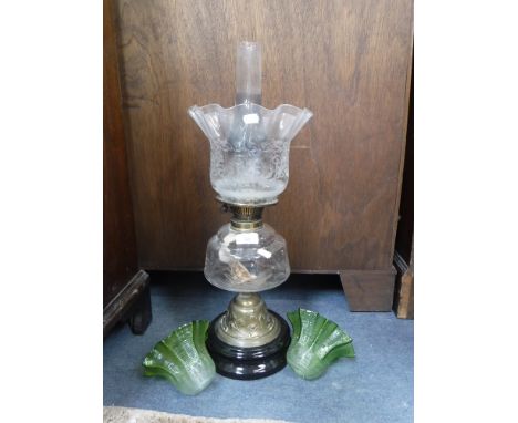 AN EDWARDIAN OIL LAMP and a pair of similar green glass electric lamp shades (3)