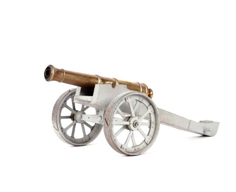 A brass model canon, on grey painted stand, 36cms long.