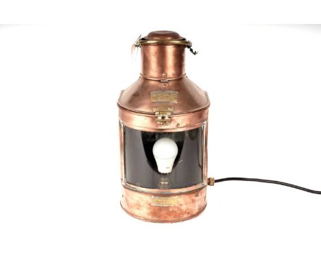 A Meteorite copper and brass ships lantern, later converted to a table lamp, wired for electricity, 47cms high (including han