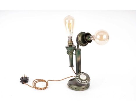 A kitsch green and gilt painted vintage stick telephone, converted to a table lamp, with light fittings to mouthpiece and ear