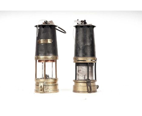 A brass and black painted miners safety lamp, by Eccles The Protector Lamp &amp; Lighting, 33cms high; together with another 