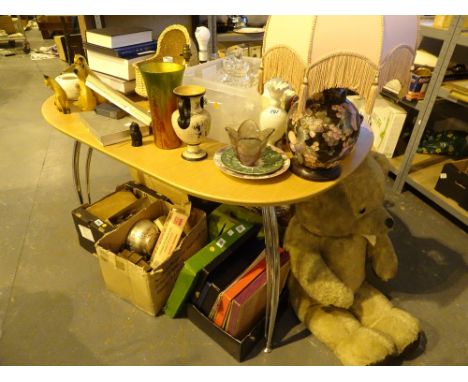 Table full of mixed items including a lamp books teddy coins and ceramics etc 