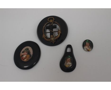 A collection of Whitby jet, comprising a portrait miniature on a black base, a further jet pendant with a portrait of a lady,