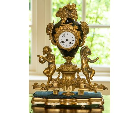A French gilt metal mounted and porcelain mantel clock, late 19th Century, the vase case of porcelain decorated with an all o