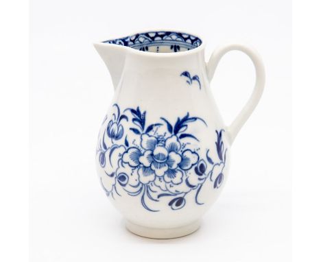A Worcester sparrow beak jug, circa 1770, of typical ovoid form with ribbed loop handle, painted in blue with a peony and oth