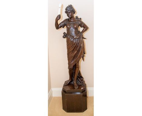 A very large carved oak figural lamp, probably French, late 19th Century, modelled as a rustic maid standing in 18th Century 