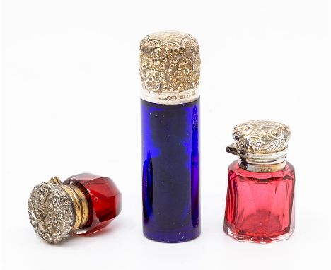 Two Victorian/Edwardian glass silver-mounted scent bottles, the first Birmingham 1891 in blue glass of cylindrical shape, 7.5