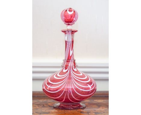 A Bohemian cranberry glass decanter and stopper, second half 19th Century, of onion form with globe stopper, decorated with t