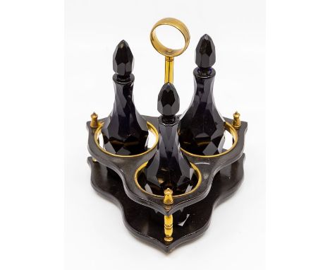 A Georgian Bristol blue glass three-bottle cruet, circa 1800-1810, the three bottles facet cut and with facet droplet stopper