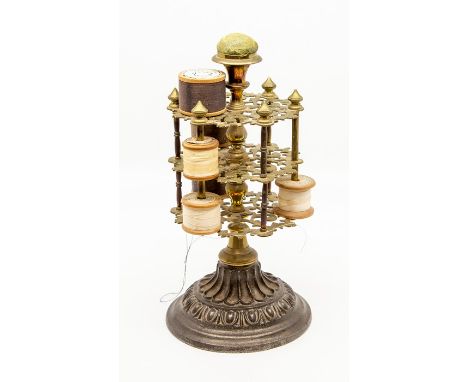 A Victorian cast iron and brass bobbin stand, the central knopped stem supporting three openwork scroll dividers with bobbin 