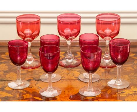 Nine various cranberry and ruby glass drinking glasses. (9)