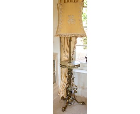 A late Victorian brass standard lamp, the reeded column with central circular onyx-mounted tier above a knopped stem with scr