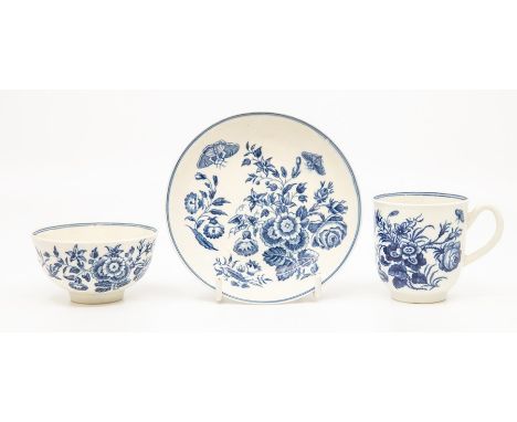 A Worcester teabowl and saucer, circa 1770-90, printed in blue with the 'Three Flowers' pattern, tramline borders to the rims