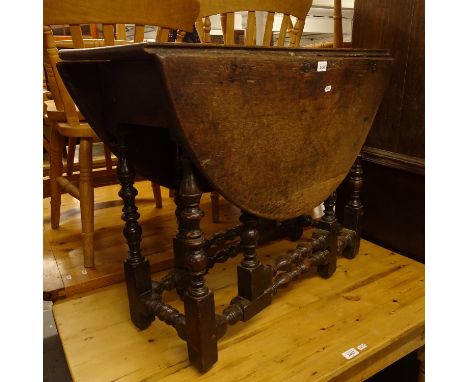 An 18th century joined oak oval gate leg table, on turned legs, W91cm 