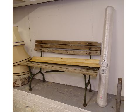 A cast-iron and slatted garden bench, L121cm, with a bundle of new slats 