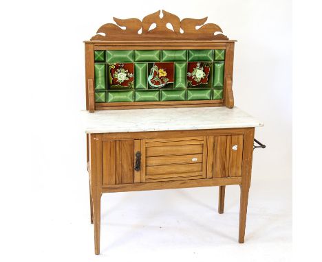 An Art Nouveau satin-walnut wash stand, with raised stylised tile-back, white marble top, raised on tapered legs, W92cm, H125