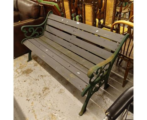 A green painted wrought-iron and slatted garden bench, L142cm 