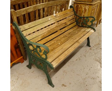 A green painted wrought-iron and slatted garden bench, W129cm 