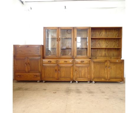 An Ercol elm 4-section dining room set, comprising cocktail cabinet, a 2-section bookcase with glazed top, a matching narrow 