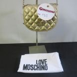 Love Moschino, Ladies Quilted PU Leather Handbag in Metallic Gold with Gold Chain Strap & Detail.