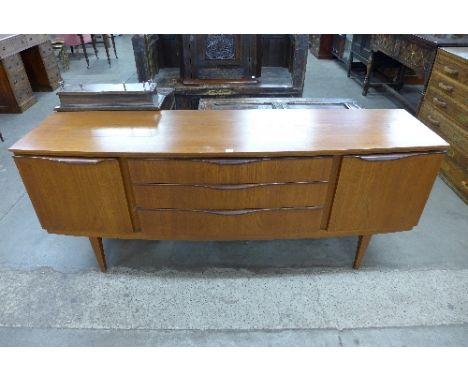 A Beautility teak bow front sideboard