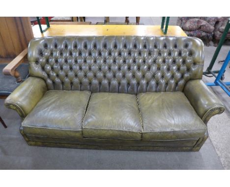 A green leather Chesterfield sofa