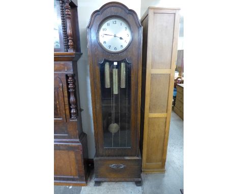 A 1930's oak triple weight longcase clock