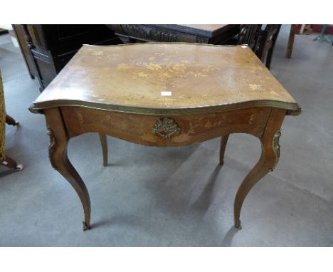 A French Louis XV style rosewood and marquetry inlaid sofa table