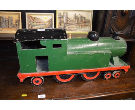 A green painted wooden model train 