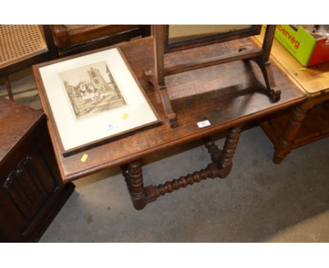 An oak oblong coffee table raised on bobbin turned supports 